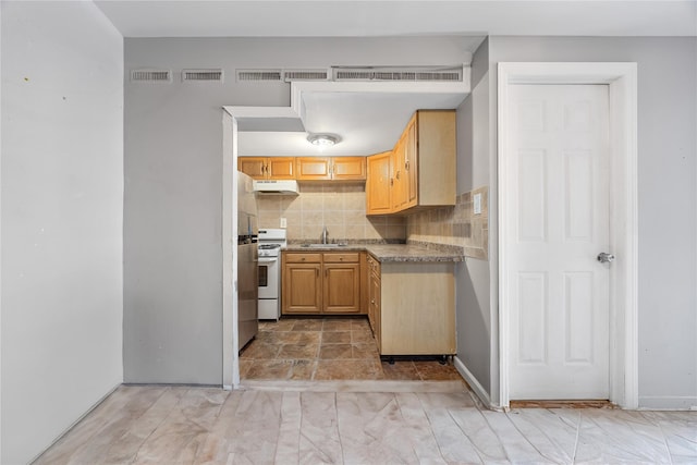 2801 Gunther Ave, Bronx, NY 10469 - kitchen with white range with gas cooktop, under cabinet range hood, light brown cabinetry, decorative backsplash, and light countertops