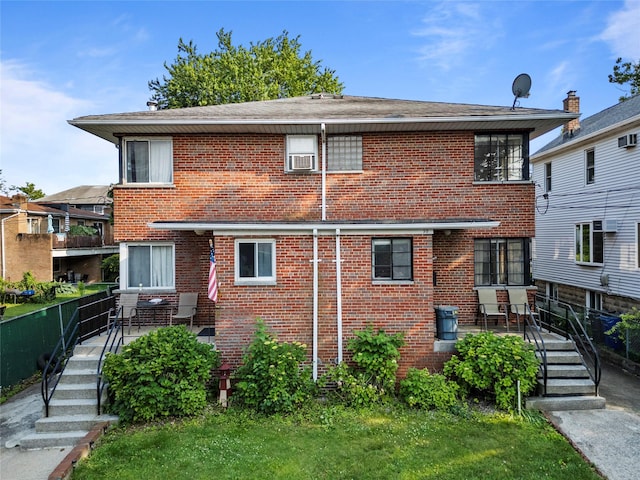 98 Pell Pl, Bronx, NY 10464 - rear view of property featuring brick siding and a patio