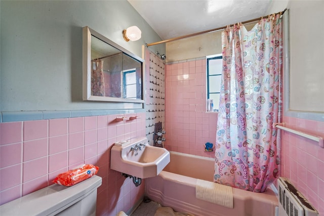 98 Pell Pl, Bronx, NY 10464 - bathroom with tile walls, radiator, and shower / bath combo with shower curtain