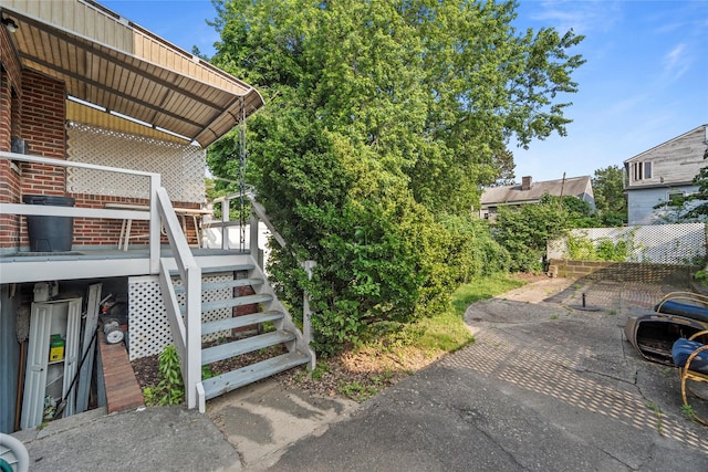 98 Pell Pl, Bronx, NY 10464 - view of home's exterior featuring stairs, a patio area, brick siding, and a deck