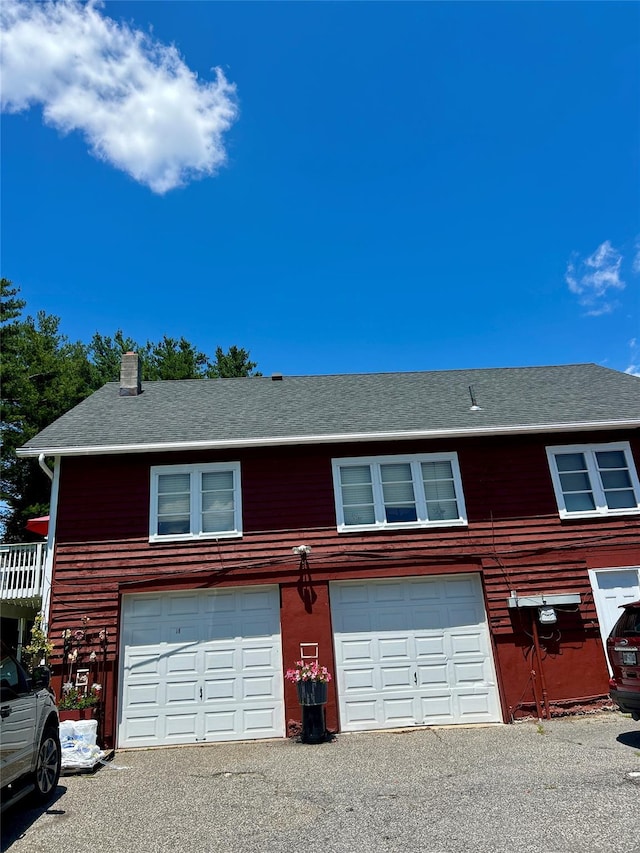 16 Rte 292 Unit 14, Patterson, NY 12563 - view of front of house with a chimney, roof with shingles, asphalt driveway, and a garage