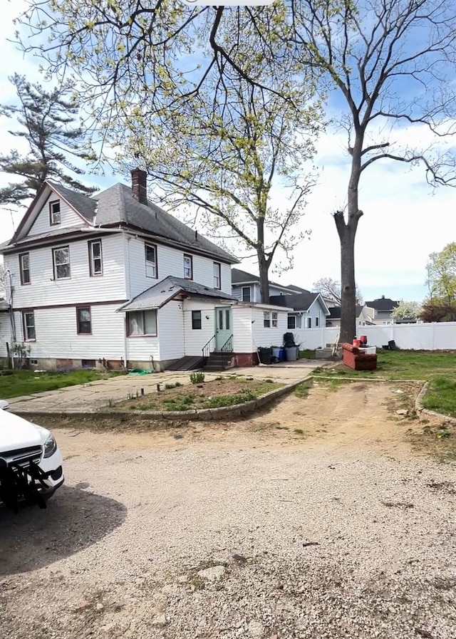 88 N Columbus, Freeport, NY 11520 - view of front facade featuring entry steps and a chimney