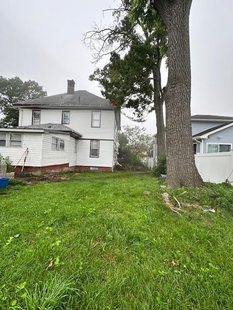 88 N Columbus, Freeport, NY 11520 - rear view of property featuring a chimney