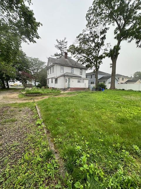 88 N Columbus, Freeport, NY 11520 - rear view of property featuring a chimney