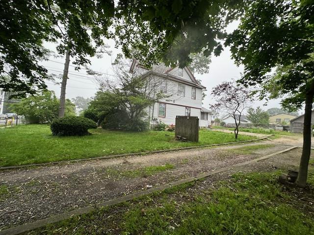 88 N Columbus, Freeport, NY 11520 - view of side of property with a yard