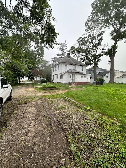 88 N Columbus, Freeport, NY 11520 - view of home's exterior featuring a chimney
