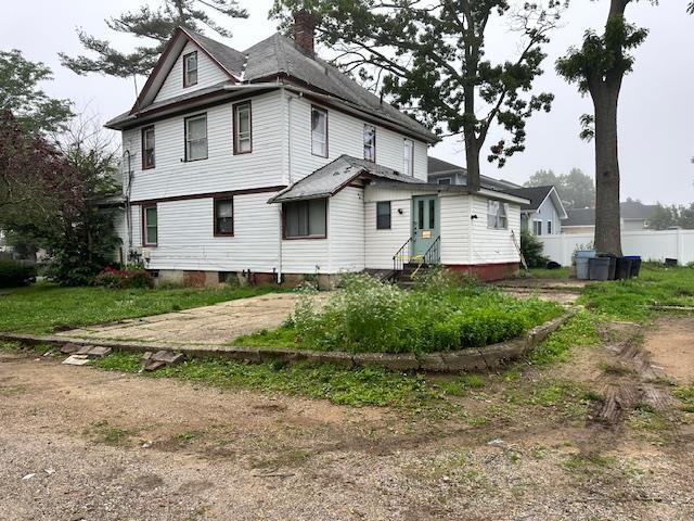 88 N Columbus, Freeport, NY 11520 - view of side of property featuring entry steps and a chimney