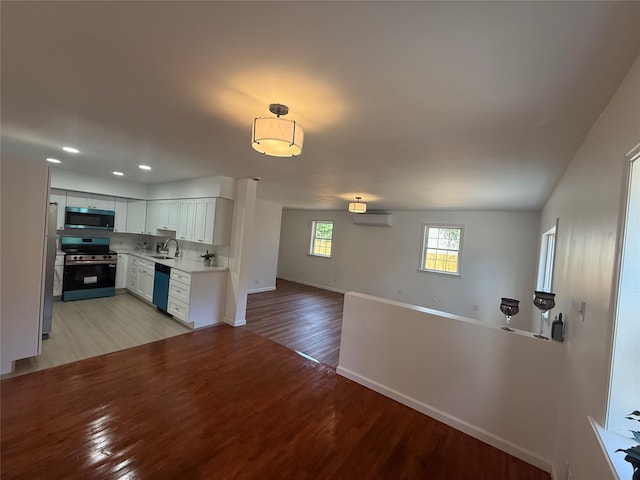 22 Hulse St, Wallkill, NY 12589 - kitchen with appliances with stainless steel finishes, open floor plan, light wood-style floors, light countertops, and recessed lighting