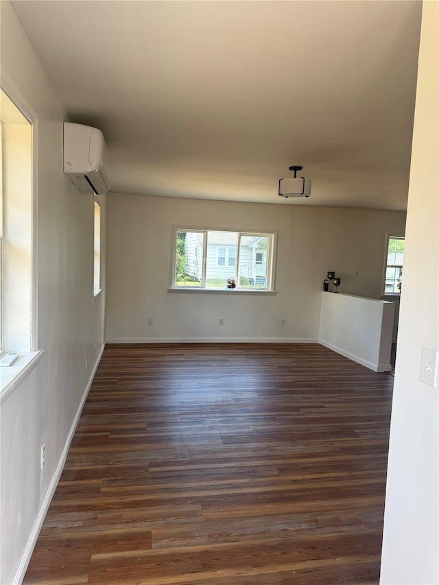 22 Hulse St, Wallkill, NY 12589 - spare room featuring an AC wall unit and dark wood-style floors