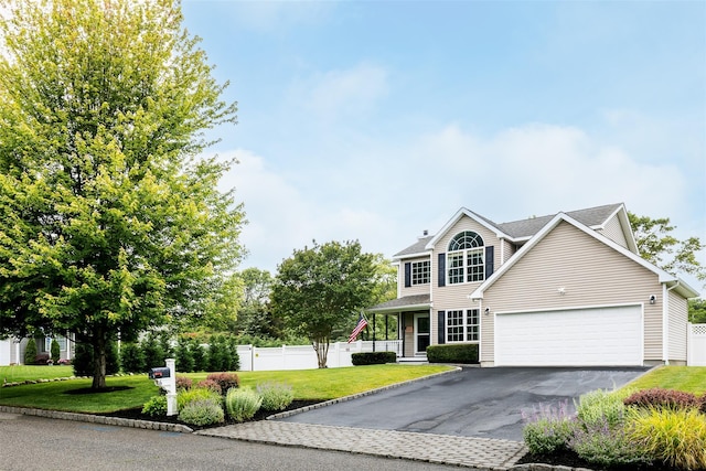 6 Danamarie Ln, East Patchogue, NY 11772 - view of front facade featuring asphalt driveway, an attached garage, and a chimney