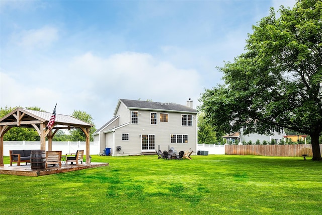 6 Danamarie Ln, East Patchogue, NY 11772 - back of property with a chimney, a gazebo, a fenced backyard, and an outdoor living space