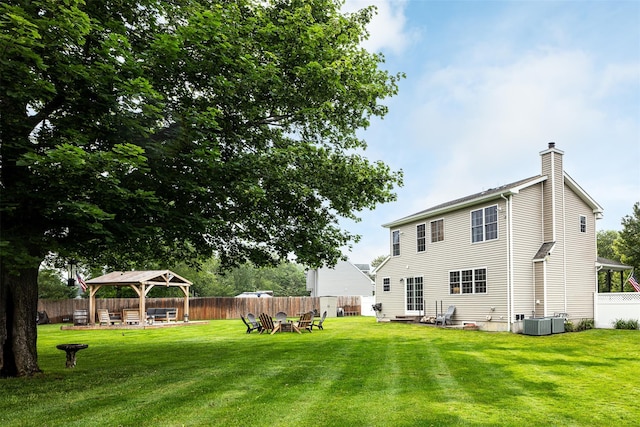 6 Danamarie Ln, East Patchogue, NY 11772 - fenced backyard with a gazebo, a hot tub, and entry steps