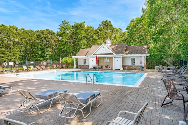 460 Old Town Rd Unit 26P, Port Jefferson Station, NY 11776 - community pool featuring a patio area and view of scattered trees