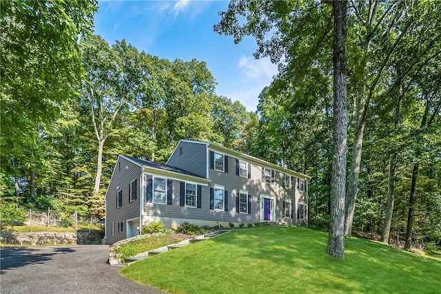 30 Hilltop Rd, Waccabuc, NY 10597 - colonial-style house featuring asphalt driveway, a front yard, and a garage