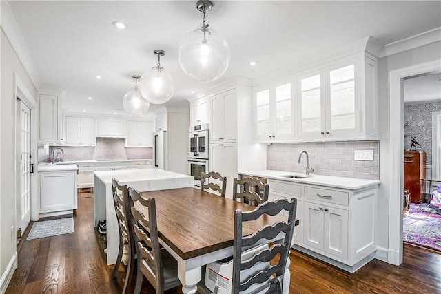 30 Hilltop Rd, Waccabuc, NY 10597 - dining space featuring dark wood finished floors, ornamental molding, and recessed lighting