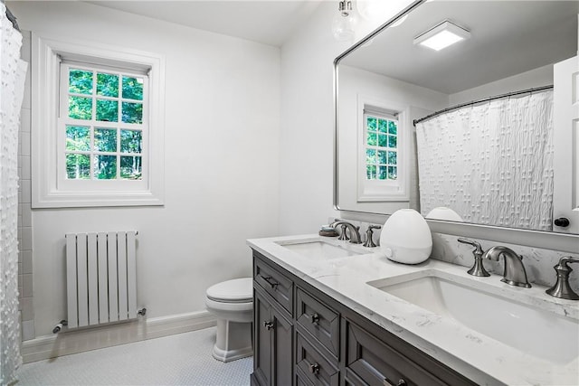 30 Hilltop Rd, Waccabuc, NY 10597 - full bathroom with radiator, double vanity, tile patterned floors, and a shower with curtain