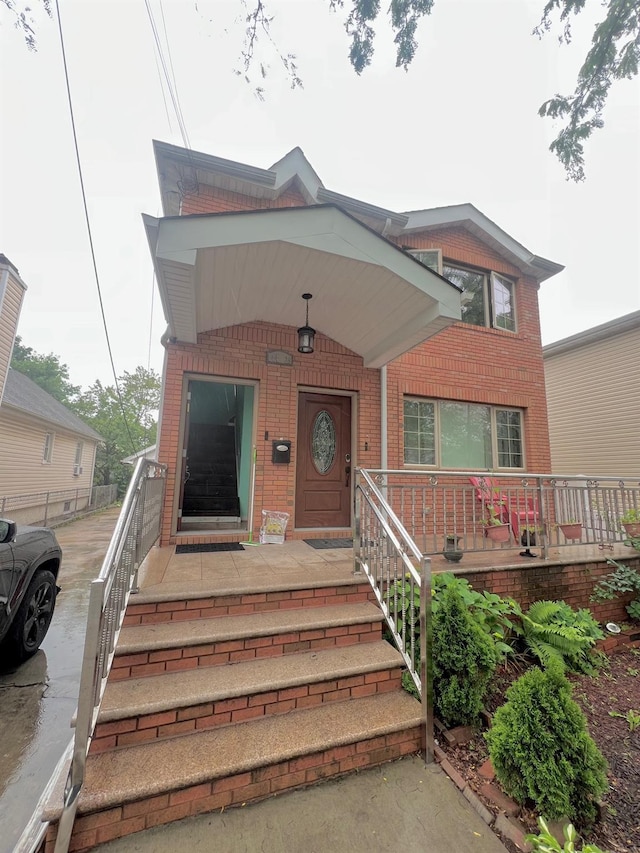 144-29 225th St, Laurelton, NY 11413 - view of front of property featuring brick siding and covered porch