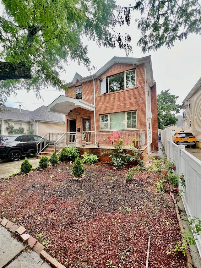 144-29 225th St, Laurelton, NY 11413 - view of front facade featuring brick siding and a porch