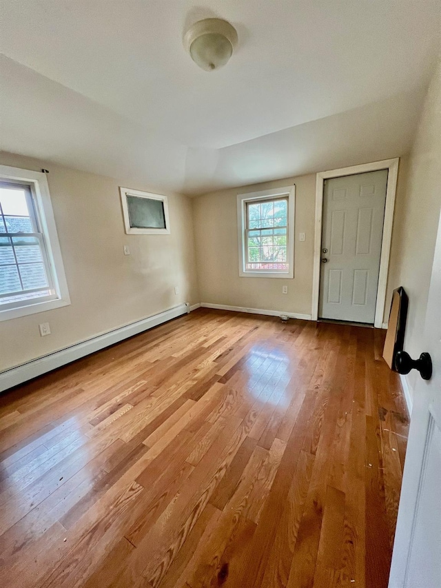 144-29 225th St, Laurelton, NY 11413 - empty room featuring a baseboard heating unit and wood finished floors