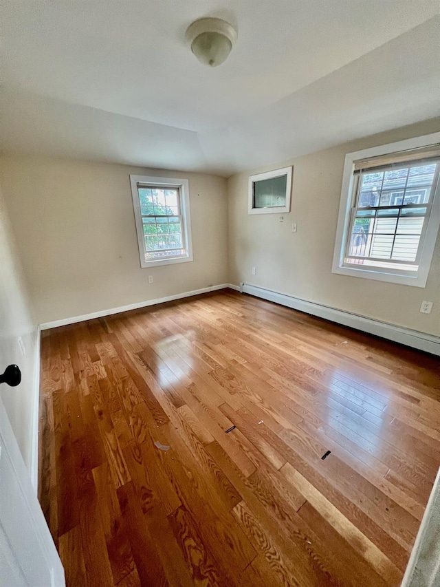 144-29 225th St, Laurelton, NY 11413 - empty room with a baseboard radiator and wood-type flooring