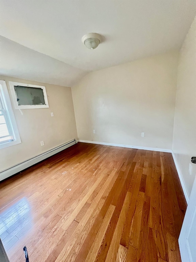 144-29 225th St, Laurelton, NY 11413 - unfurnished room featuring hardwood / wood-style flooring, a baseboard radiator, and vaulted ceiling