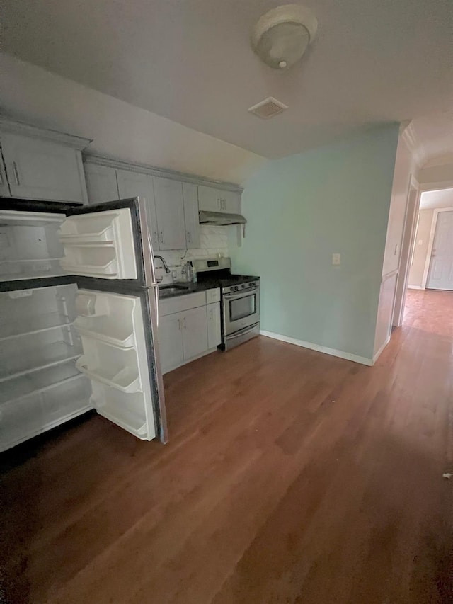 144-29 225th St, Laurelton, NY 11413 - kitchen with stainless steel range with gas stovetop, under cabinet range hood, wood finished floors, freestanding refrigerator, and dark countertops