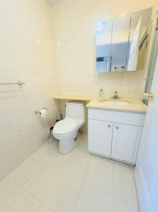 143-26 41st Ave Unit 10C, Flushing, NY 11355 - bathroom with tile walls, vanity, and tile patterned flooring