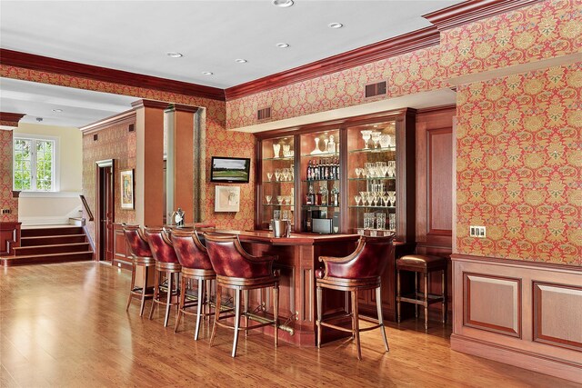 4 Pond Ln, Sands Point, NY 11050 - community bar area with wallpapered walls, ornamental molding, wood finished floors, a wainscoted wall, and stairway