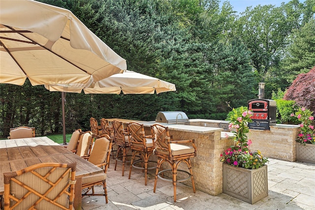 4 Pond Ln, Sands Point, NY 11050 - view of patio / terrace featuring exterior kitchen and outdoor dining space