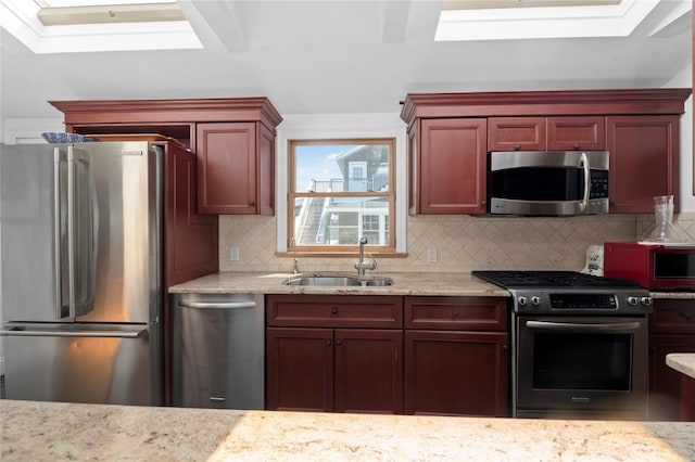 165 Bay Walk, Ocean Beach, NY 11770 - kitchen with stainless steel appliances, decorative backsplash, reddish brown cabinets, and light stone counters