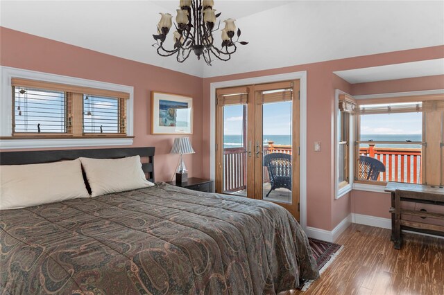 165 Bay Walk, Ocean Beach, NY 11770 - bedroom with a water view, access to outside, french doors, wood finished floors, and a chandelier