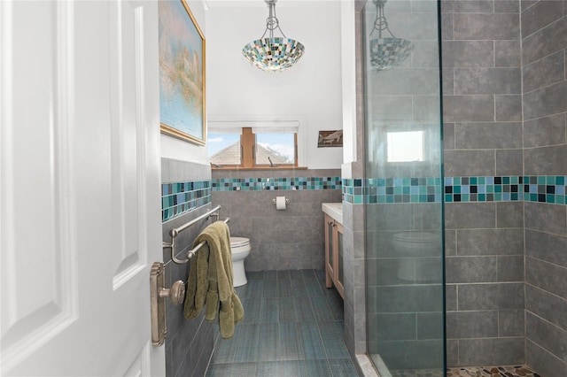 165 Bay Walk, Ocean Beach, NY 11770 - full bath featuring a tile shower, vanity, tile walls, tile patterned flooring, and a wainscoted wall