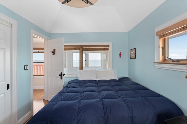 165 Bay Walk, Ocean Beach, NY 11770 - bedroom with multiple windows, vaulted ceiling, and wood finished floors