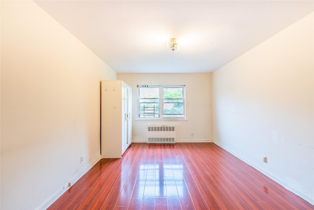 40-04 149th St, Flushing, NY 11354 - spare room featuring radiator and wood finished floors