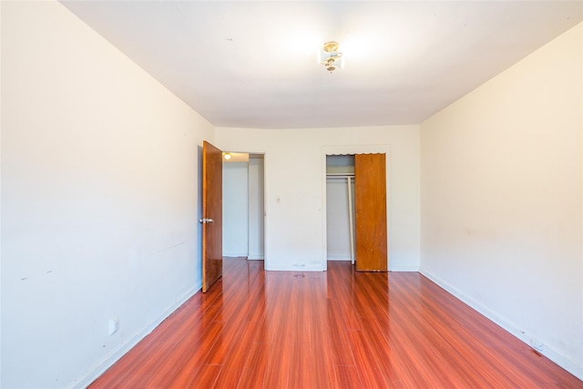 40-04 149th St, Flushing, NY 11354 - unfurnished bedroom featuring wood finished floors and a closet