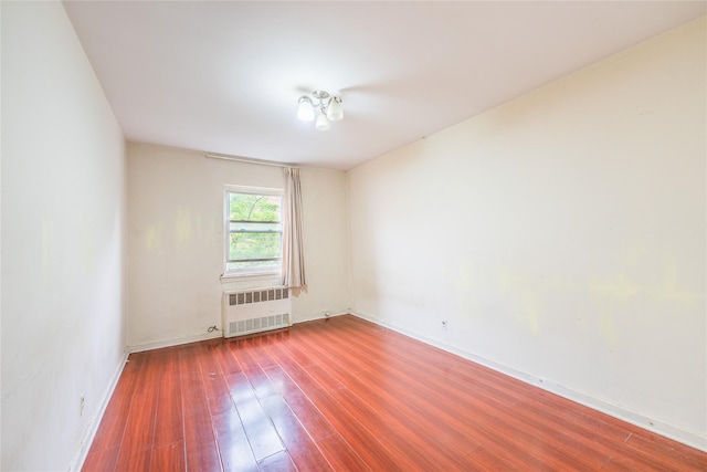 40-04 149th St, Flushing, NY 11354 - empty room with radiator and wood finished floors