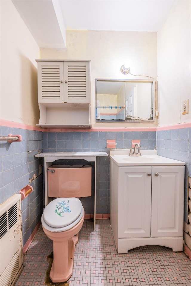 40-04 149th St, Flushing, NY 11354 - half bathroom featuring radiator heating unit, tile walls, wainscoting, and vanity