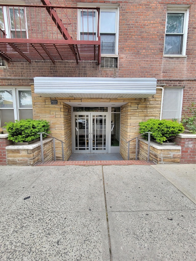 1332 Metropolitan Ave Unit 6A, Bronx, NY 10462 - view of exterior entry featuring french doors and brick siding