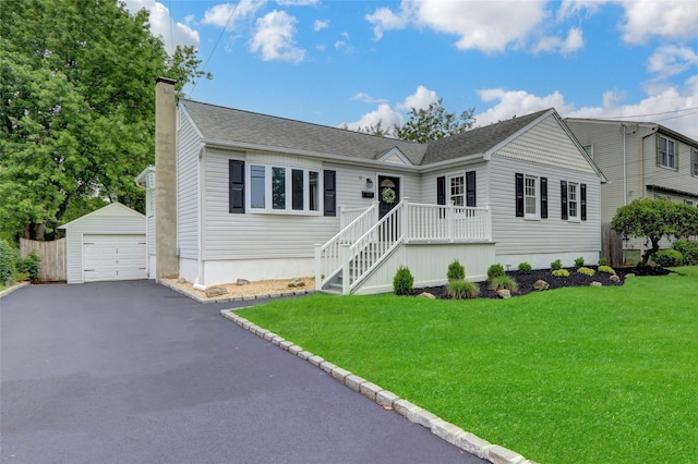 31 Tappan Ave, Babylon, NY 11702 - ranch-style house featuring a chimney, a detached garage, an outbuilding, a front yard, and driveway