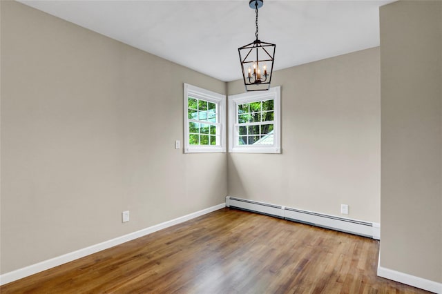 31 Tappan Ave, Babylon, NY 11702 - unfurnished room with a baseboard radiator, wood finished floors, and a chandelier