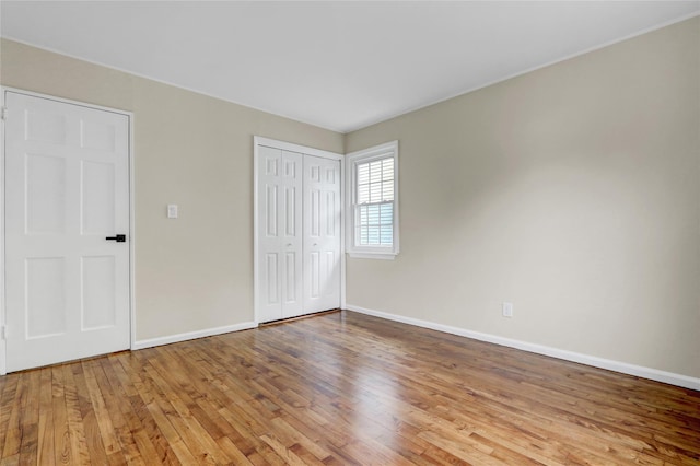 31 Tappan Ave, Babylon, NY 11702 - unfurnished bedroom with wood-type flooring and a closet