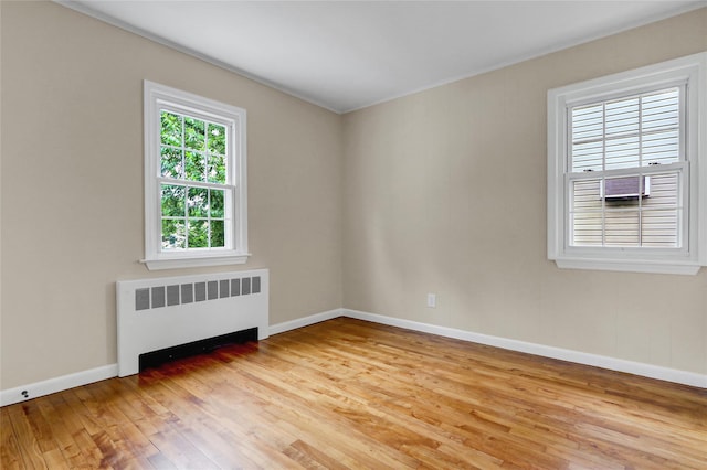 31 Tappan Ave, Babylon, NY 11702 - unfurnished room featuring radiator heating unit and light wood-style floors