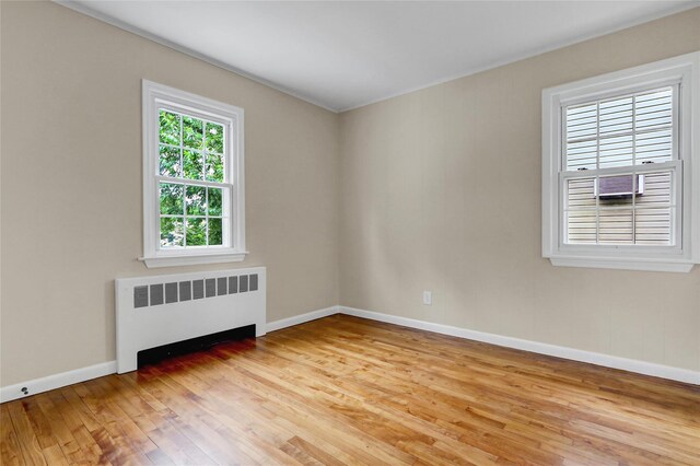 31 Tappan Ave, Babylon, NY 11702 - empty room with radiator heating unit and light wood-style floors