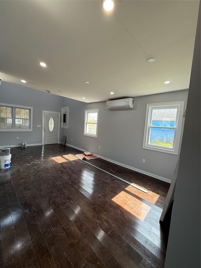 4006 Rockaway Beach Blvd, Edgemere, NY 11691 - unfurnished living room with a wall unit AC, hardwood / wood-style floors, and recessed lighting