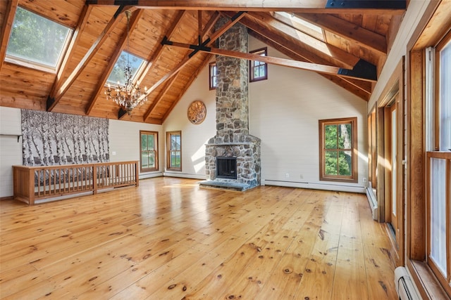 25 Cascade Lake Rd, Warwick, NY 10990 - unfurnished living room featuring baseboard heating, high vaulted ceiling, hardwood / wood-style floors, a chandelier, and a skylight