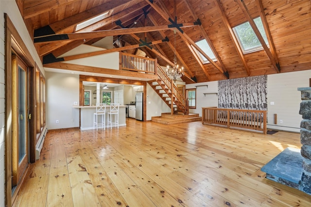 25 Cascade Lake Rd, Warwick, NY 10990 - unfurnished living room featuring a skylight, light wood finished floors, high vaulted ceiling, a chandelier, and a baseboard heating unit