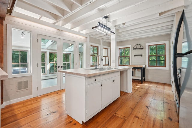 25 Cascade Lake Rd, Warwick, NY 10990 - kitchen featuring freestanding refrigerator, french doors, light wood-style floors, an island with sink, and beam ceiling