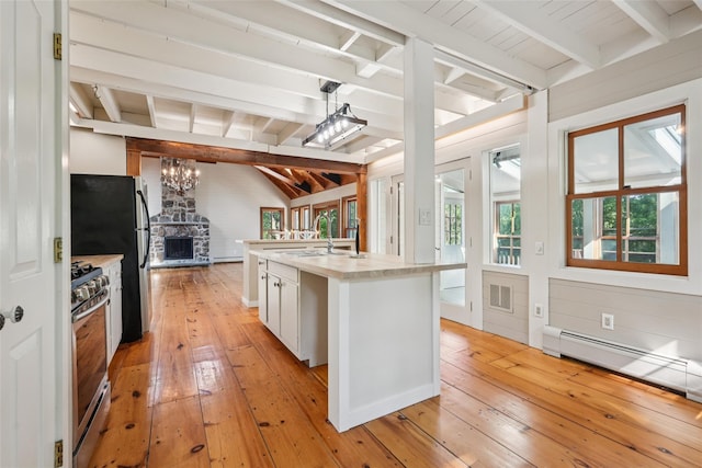25 Cascade Lake Rd, Warwick, NY 10990 - kitchen featuring appliances with stainless steel finishes, light wood-style floors, light countertops, a chandelier, and open floor plan