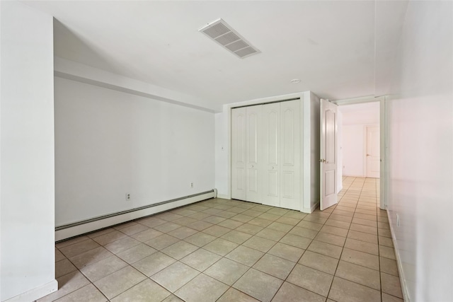 25 Cascade Lake Rd, Warwick, NY 10990 - unfurnished bedroom with a baseboard radiator, light tile patterned floors, and a closet