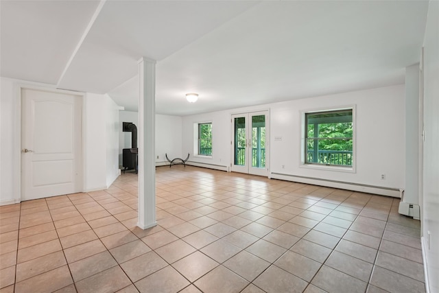 25 Cascade Lake Rd, Warwick, NY 10990 - unfurnished living room featuring a baseboard heating unit, plenty of natural light, and light tile patterned floors